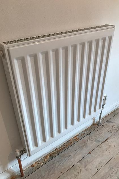 Cottage renovation, radiator installation